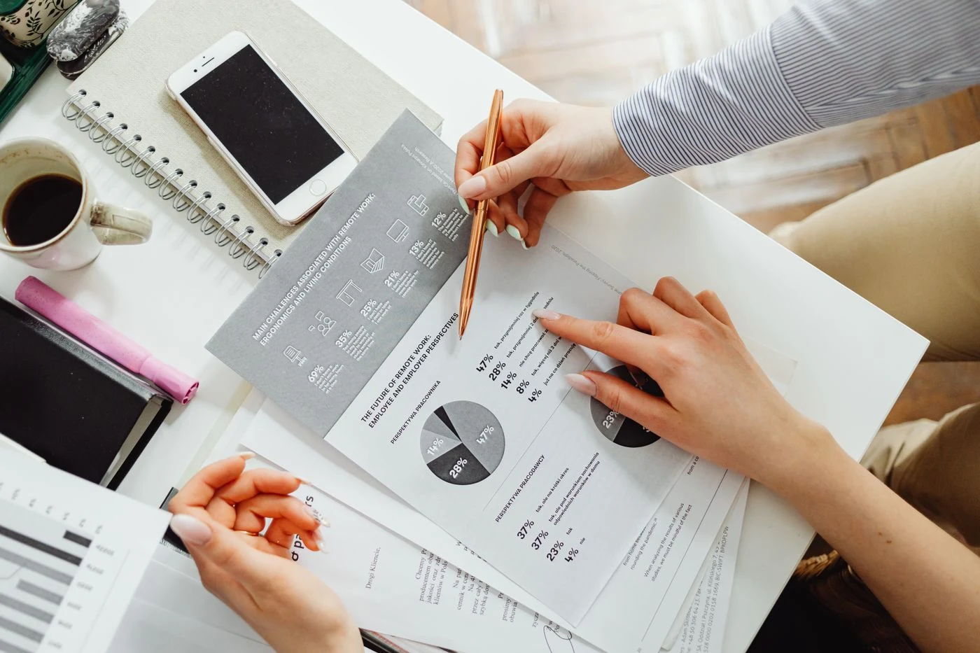An accountant reviewing financial statements with a pen